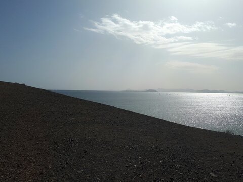 Sunlight reflecting on the Atlantic Ocean from a volcanic beach in Lanzarote, Canary Islands, Spain