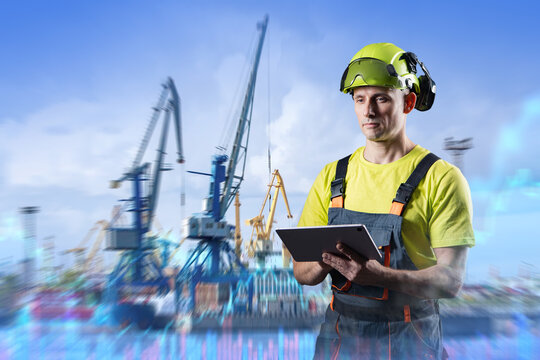 Port logistics. Port worker manages cargo handling operations at container terminal using tablet for shipping and logistics coordination.