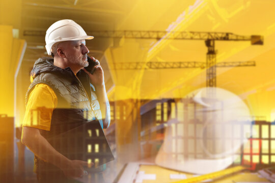 Construction management. Construction supervisor coordinates building project by phone at construction site during planning and site inspection.