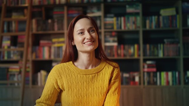 Young red-haired woman checking phone after being stood up on library date