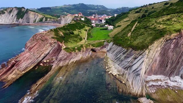 Scenic drone shot of Atlantic coast in Basque Country, Zumaia coast in Flysch with beautiful rocks, aerial view of ocean landscape in northern Spain, Spanish Atlantic coast