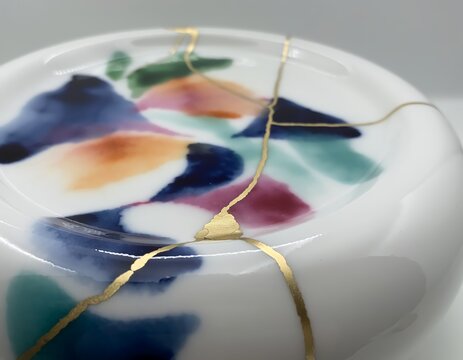Artistic Kintsugi Restoration on Glossy White Ceramic Surface with Vibrant Abstract Painted Patterns