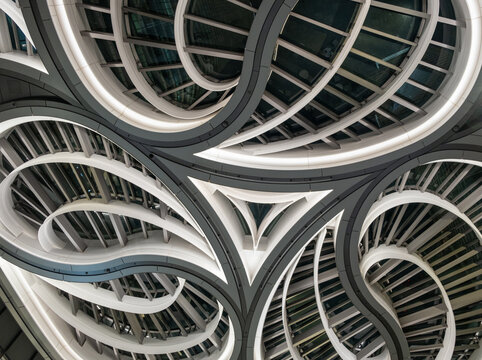 Luminous circular ceiling structures in modern glass and metal architectural interior, Japan