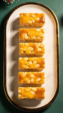 Golden honey macadamia nut bars on oval plate