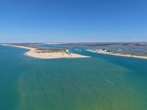 Aerial view from the Atlantic Ocean towards the Ca&ntilde;o de Sancti Petri, between a sandspit and the Puerto Deportivo de Sancti Petri marina; C&aacute;diz, San Fernando, and Chiclana de la Frontera, Spain