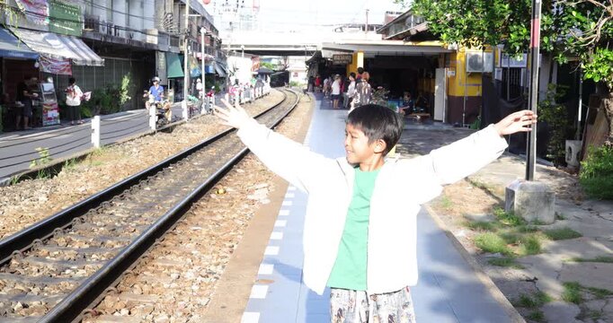 Little school boy enjoy travel at Talat Phlu train station sightseeing travel in Bangkok Thailand