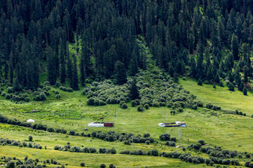 Alpine valley landscape on Genie South Line Sichuan China, winding river, grassland village and dense coniferous forest on western Sichuan plateau © Deng Xuejun