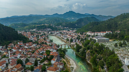 Naklejka premium Aerial view of Konjic old stone bridge over emerald Neretva river in Bosnia and Herzegovina