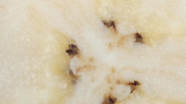 Extreme close-up macro footage of a banana sliced in half, showing its natural texture and flesh in detail.