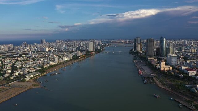 Aerial drone footage of Da Nang city skyline and the iconic bridges spanning the Han River, Vietnam. The clip features panoramic views of Dragon Bridge (Cau Rong), Tran Thi Ly Bridge, Thuan Phuoc 