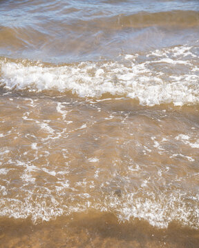 Wave detail at a beach in a sunny day