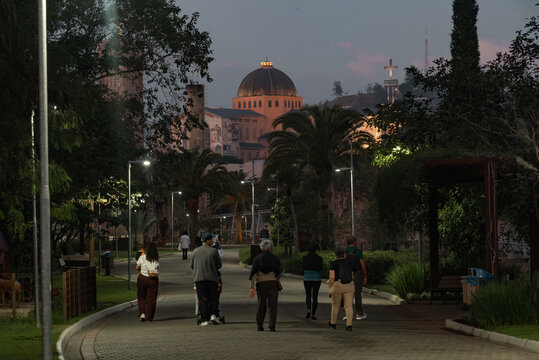 A Family Walking Toward the Illuminated Bas&iacute;lica de Nossa Senhora Aparecida at Dusk