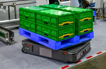 Autonomous mobile robot AMR AGV carrying blue plastic pallet with green crates in modern smart warehouse factory © I Viewfinder