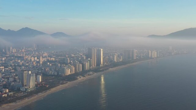 Aerial drone footage of Da Nang city skyline and the iconic bridges spanning the Han River, Vietnam. The clip features panoramic views of Dragon Bridge (Cau Rong), Tran Thi Ly Bridge, Thuan Phuoc 