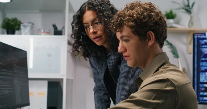 Latin software developer and colleague discuss architecture debug applications optimize queries and plan deployment while coordinating with product and marketing teams.