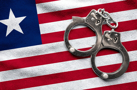 Flag of Flag of Liberia and police handcuffs. Crime and offenses in country Concept
