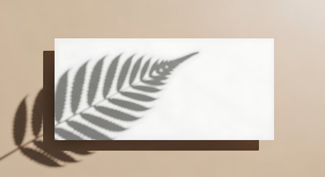 Natural leaf shadow falling upon a blank paper rectangle showcasing botanical aesthetics for creative stationery presentation layouts and design projects requiring gentle organic shadows