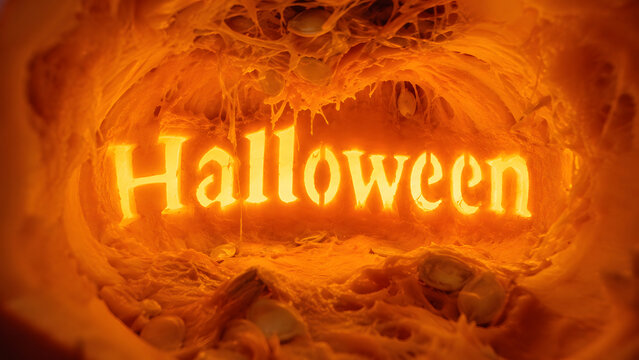 Halloween lettering glows inside an intense orange organic tunnel with web-like textures and a dramatic horror atmosphere.