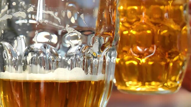 Beer for Oktoberfest Celebration..Two people are drinking beer, clinking their mugs together in a friendly toast.