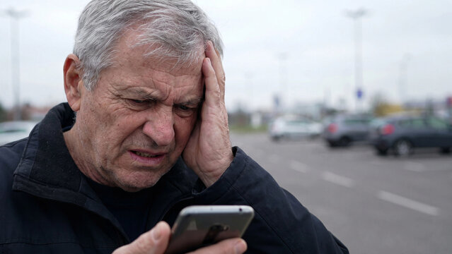 Senior phone scam and fraud awareness concept for elderly cybersecurity protection distressing news and digital safety challenges outdoors