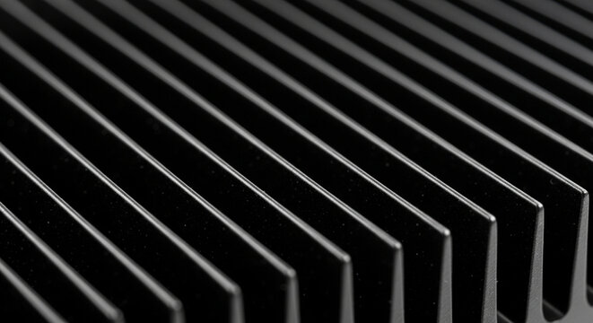 Close-up of black metal heatsink fins, industrial texture, abstract background