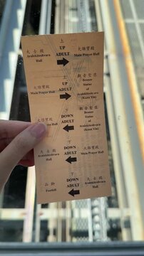 Penang, Malaysia on 1 April 2025: a close-up of the inclined lift ticket for Kek Lok Si Temple, showing directions and access to the Main Prayer Hall, Avalokiteshvara Hall, and others in the Temple