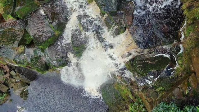 Aerial drone footage of a tall rocky waterfall in the Yorkshire Dales, Pennies. Moorland scene of a majestic waterfalls near Marsden West Yorkshire. Huddersfield Outdoors