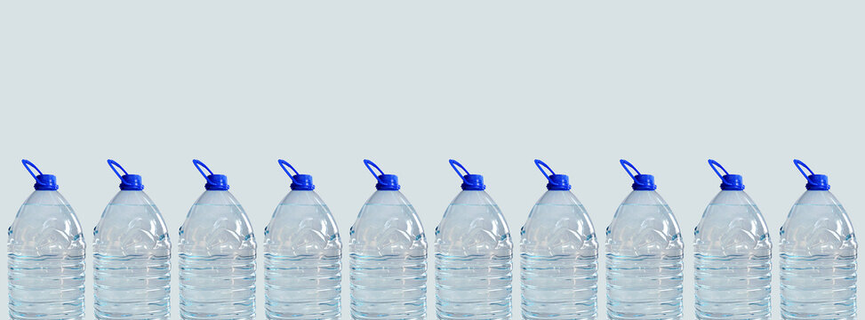 Water bottles in row banner, isolated on light background. Transparent 5l bottles, full, blue cap. Drinking water supply concept. Horizontal studio shot