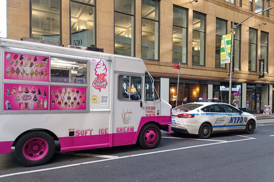 Soft ice cream truck and NYPD police car parked on a New York City street, USA, June 19, 2026.
