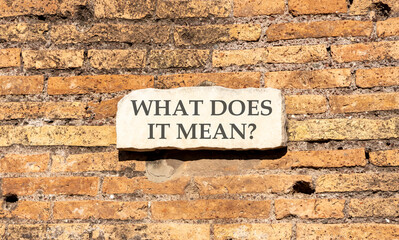 Fototapeta premium What does it mean words symbol. Concept words What does it mean on beautiful white sign plate. Beautiful brown brick wall background. Business What does it mean motivational support concept Copy space