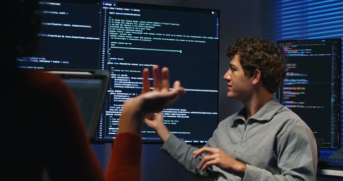 Hispanic engineers collaborate on application security monitor logs optimize networks and write production code for scalable cloud and database solutions during late hours