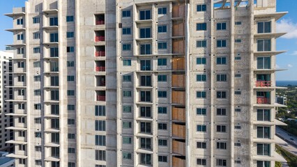 High-rise condominium tower facade under construction with balconies © Francisco