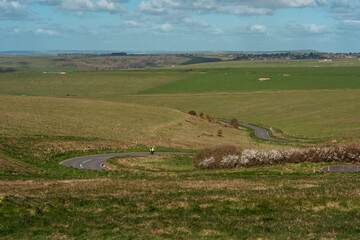 Obraz premium Countryside Road with Cyclist at Seven Sisters near Hastings