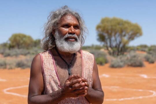 Aboriginal elder speaking in the australian outback desert