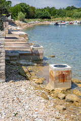 Fototapeta premium Concrete pier and pebble beach. Adriatic coast, Istria, Croatia.
