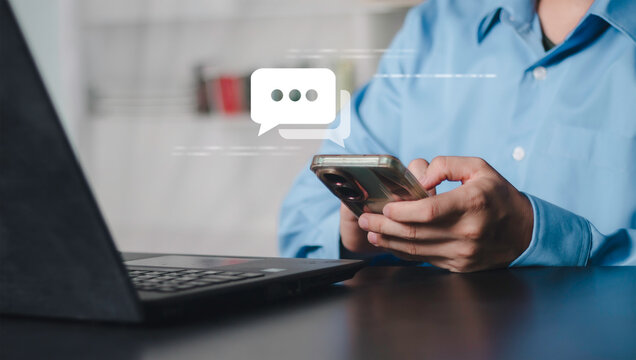 Businessman using smartphone with chat message icon, online communication, notification, instant messaging, customer support, social interaction and digital conversation technology.