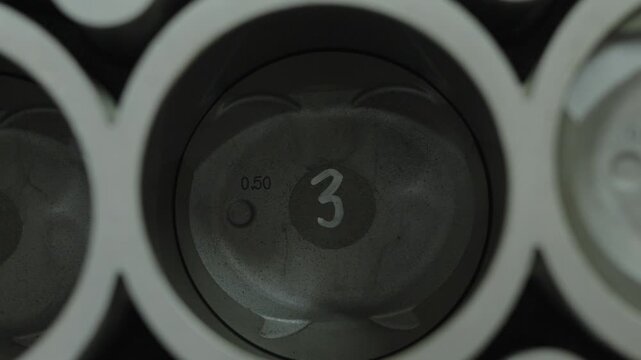 Top down close-up of piston number three inside engine cylinder.