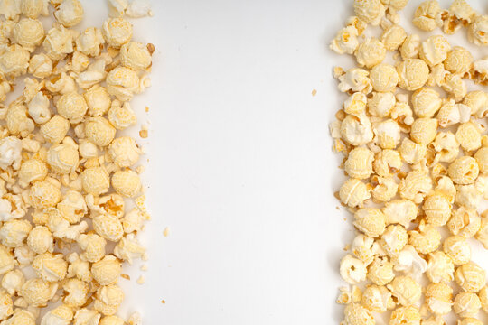 Top view frame of fresh popcorn on left and right sides with central copy space on white background