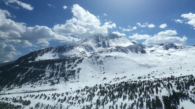 Aerial Close-Up of Sunlit Snowy Pyrenean Peak, Andorra 4k drone