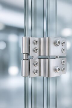 Glass hinge hardware detail on frameless glass door for interior and architectural design background and product presentation