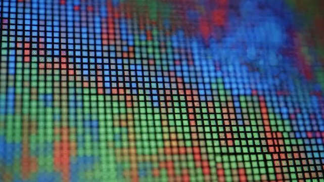 Closeup of a digital screen display with colorful pixel grid pattern