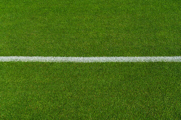 Fototapeta premium textured soccer game field with free copy space background - line in stadium midfield