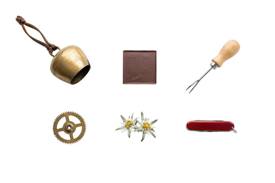 Traditional Swiss culture icons set, brass cowbell and edelweiss flowers on white background, chocolate bar and pocket knife travel souvenirs
