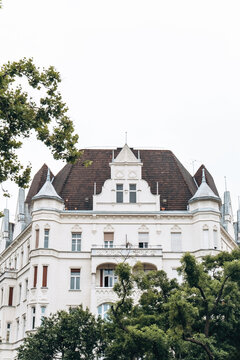 An elegant white building surrounded by Lush Greenery and stunning hstoric architecture