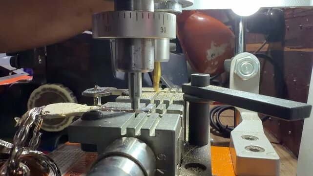 Close-up video of a locksmith duplicating a metal key with a precision key cutting machine, showcasing professional security service, craftsmanship, hardware repair and key replacement.