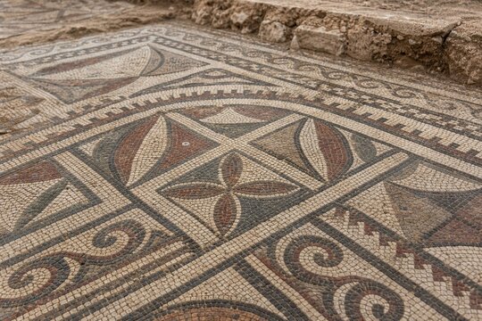 Close-up of ancient mosaic floor with geometric patterns, archaeological texture.