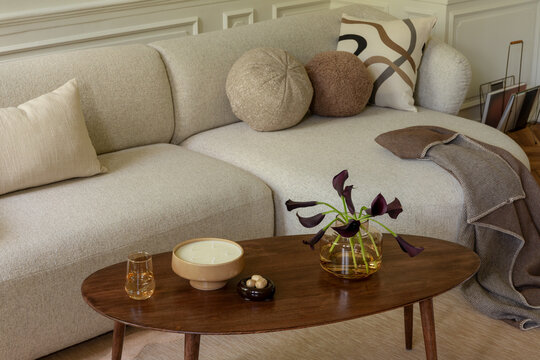 Inviting Living Room Scene with Cozy Sofa, Warm Decor, and Subtle Floral Arrangement