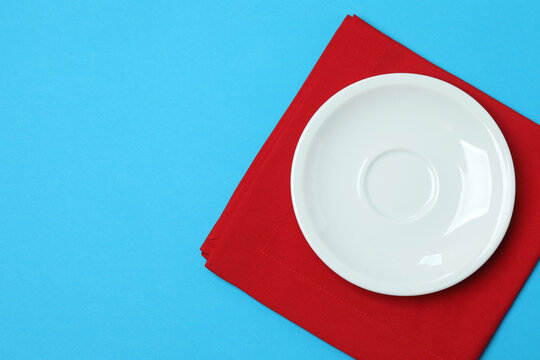 Top view of empty round plate on colorful background,Empty dish on napkin with space for your design.
