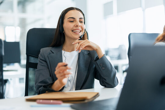 Female call center agent wearing headset providing customer service