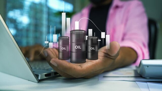 Business person working on a laptop with a hologram digital oil barrel and rising chart above the hand, Holograph energy investment price growth trading and market analysis in an office